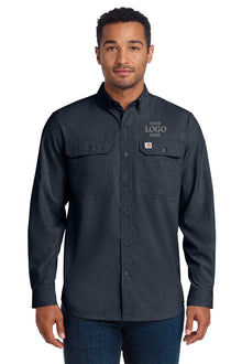 Man wearing a dark gray button-up shirt with 'Carhartt' logo on a white background embroidered Carhartt Force® Solid Long Sleeve Shirt