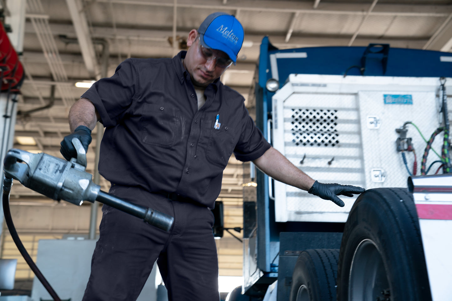 Mechanic working on a vehicle tire in a garage