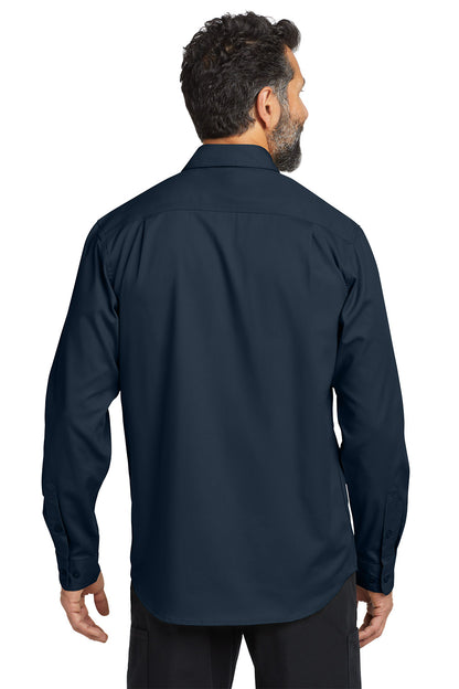 Man wearing a navy long-sleeve shirt on a white background embroidered Carhartt® Rugged Professional™ Series Long Sleeve Shirt