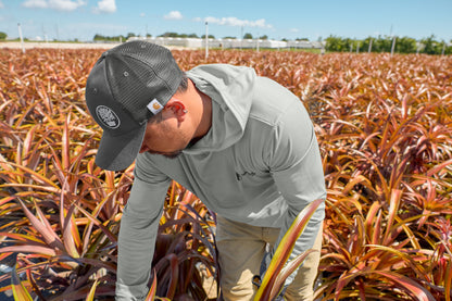 Person inspecting plants in a field with a clear sky, Carhartt® Rugged Professional™ Series Cap, Embroidered
