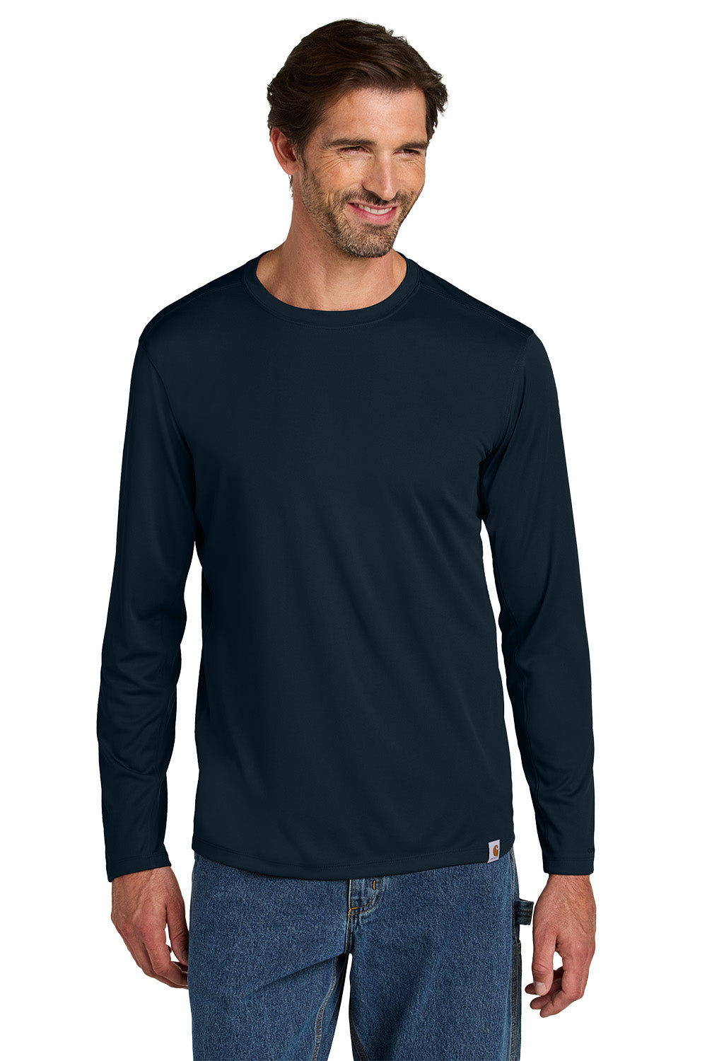 Man wearing a navy long-sleeve shirt and blue jeans on a white background embroidered Carhartt Force® Sun Defender™ Long Sleeve Shirt