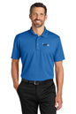 Man wearing a blue polo shirt and black pants on a white background. Port Authority® Plaited Pique Polo, Creative Technologies Academy embroidered by Helmsman Stitch Co.