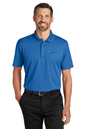 Man wearing a blue polo shirt and black pants on a white background. Port Authority® Plaited Pique Polo, Creative Technologies Academy embroidered by Helmsman Stitch Co.