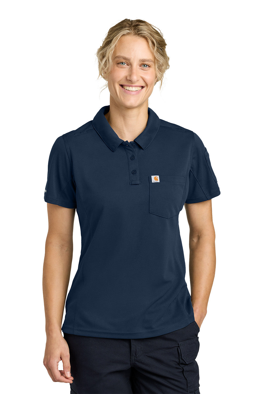 Person wearing a navy blue polo shirt with a visible brand logo on a white background, Carhartt® Women’s FLD & RSCU Polo, Embroidered
