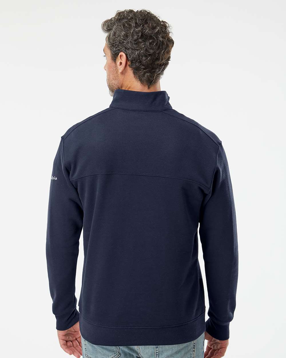 Man wearing a navy blue jacket on a white background. Columbia Men's Hart Mountain™ II Half-Zip Pullover, Embroidered by Helmsman Stitch Co.