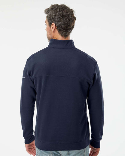 Man wearing a navy blue jacket on a white background. Columbia Men's Hart Mountain™ II Half-Zip Pullover, Embroidered by Helmsman Stitch Co.