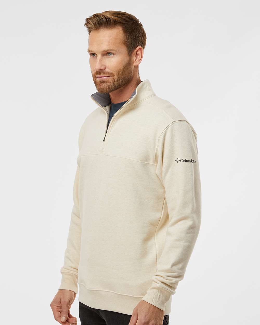 Man wearing a cream-colored half-zip sweatshirt with Columbia logo on a white background. Columbia Men's Hart Mountain™ II Half-Zip Pullover, Embroidered by Helmsman Stitch Co.