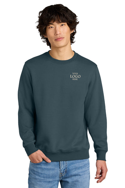 Person wearing a dark blue sweatshirt with 'PLACE LOGO HERE' text on a white background, Embroidered District® Perfect Weight® Fleece Crew