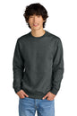 Man wearing a dark gray sweatshirt and blue jeans on a white background, Embroidered District® Perfect Weight® Fleece Crew