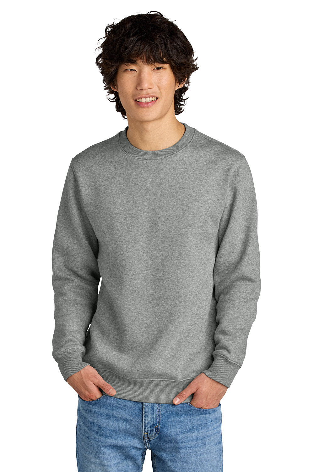 Man wearing a gray sweatshirt and blue jeans on a white background, Embroidered District® Perfect Weight® Fleece Crew