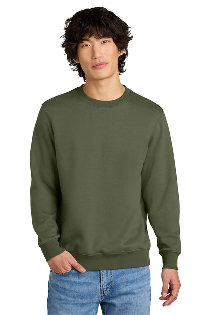 Man wearing an olive green sweatshirt and blue jeans on a white background, Embroidered District® Perfect Weight® Fleece Crew