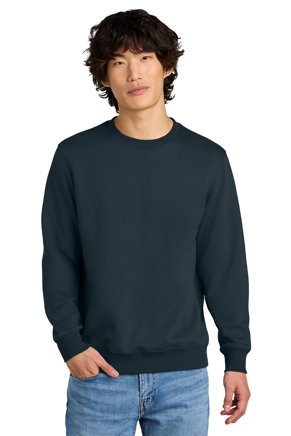 Person wearing a navy blue sweatshirt and light blue jeans on a white background, Embroidered District® Perfect Weight® Fleece Crew