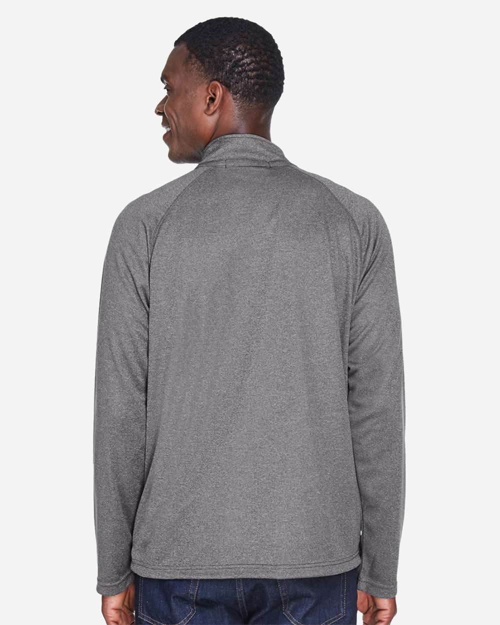 Man wearing a gray long-sleeve shirt on a white background. Devon & Jones Men's Stretch Tech-Shell® Compass Quarter-Zip Pullover, Embroidered by Helmsman Stitch Co.