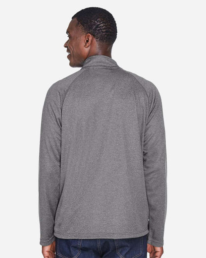 Man wearing a gray long-sleeve shirt on a white background. Devon & Jones Men's Stretch Tech-Shell® Compass Quarter-Zip Pullover, Embroidered by Helmsman Stitch Co.