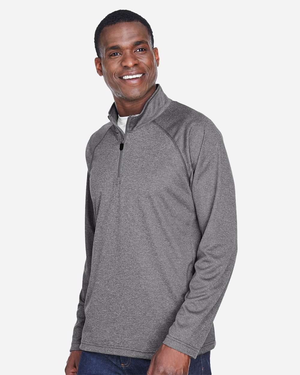 Man wearing a gray pullover with a white background. Devon & Jones Men's Stretch Tech-Shell® Compass Quarter-Zip Pullover, Embroidered by Helmsman Stitch Co.