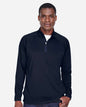 Man wearing a navy long-sleeve shirt with a white collar on a light gray background. Devon & Jones Men's Stretch Tech-Shell® Compass Quarter-Zip Pullover, Embroidered by Helmsman Stitch Co.