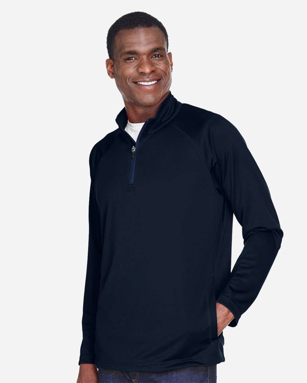 Man wearing a black long-sleeve shirt with a quarter-zip on a white background. Devon & Jones Men's Stretch Tech-Shell® Compass Quarter-Zip Pullover, Embroidered by Helmsman Stitch Co.