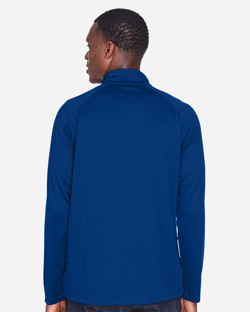 Person wearing a blue long-sleeve shirt on a white background. Devon & Jones Men's Stretch Tech-Shell® Compass Quarter-Zip Pullover, Embroidered by Helmsman Stitch Co.