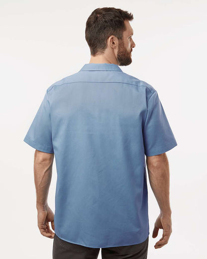 Man wearing a blue short-sleeve shirt on a white background. Dickie's Men's Shirt Sleeve Work Shirt, Embroidered by Helmsman Stitch Co.