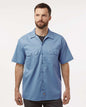 Man wearing a blue short-sleeve shirt on a white background. Dickie's Men's Shirt Sleeve Work Shirt, Embroidered by Helmsman Stitch Co.