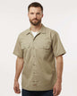 Man wearing a beige short-sleeve shirt on a white background. Dickie's Men's Shirt Sleeve Work Shirt, Embroidered by Helmsman Stitch Co.