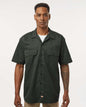 Man wearing a dark green short-sleeve shirt on a white background. Dickie's Men's Shirt Sleeve Work Shirt, Embroidered by Helmsman Stitch Co.