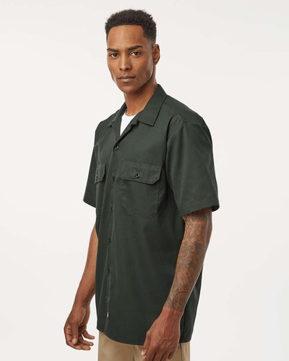 Man wearing a dark green short-sleeve shirt on a white background. Dickie's Men's Shirt Sleeve Work Shirt, Embroidered by Helmsman Stitch Co.