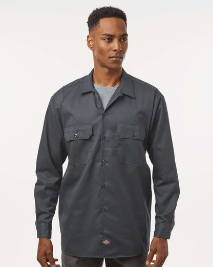 Man wearing a dark gray button-up shirt on a white background. Dickie's Men's Long Sleeve Work Shirt, Embroidered by Helmsman Stitch Co.