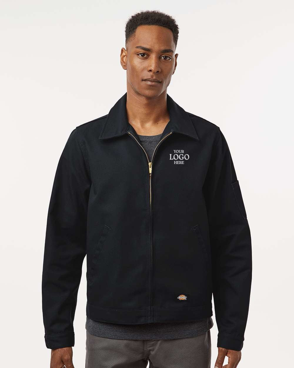 Man wearing a black jacket with customizable logo text on a white background. Dickie's Men's Unlined Industrial Eisenhower Jacket, Embroidered