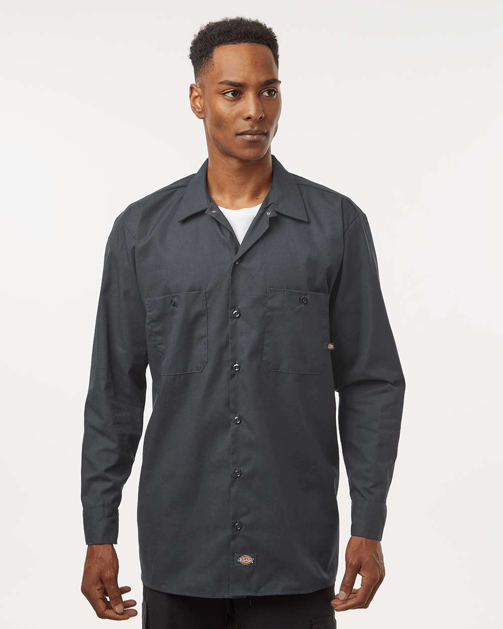 Man wearing a dark gray button-up shirt on a white background. Dickie's Men's Industrial long Sleeve Work Shirt, Embroidered by Helmsman Stitch Co.