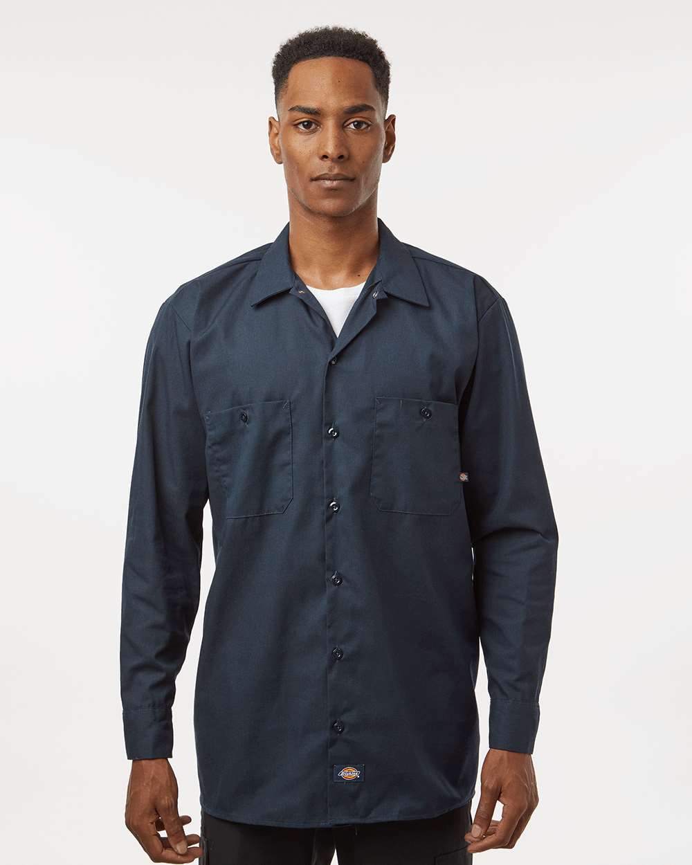 Man wearing a dark blue button-up shirt on a white background. Dickie's Men's Industrial long Sleeve Work Shirt, Embroidered by Helmsman Stitch Co.
