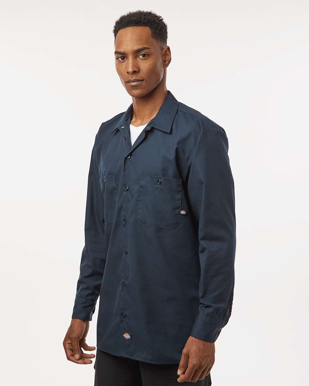 Man wearing a navy blue jacket on a white background. Dickie's Men's Industrial long Sleeve Work Shirt, Embroidered by Helmsman Stitch Co.
