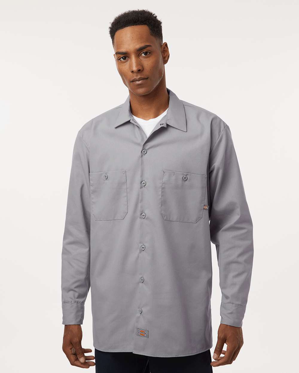 Man wearing a gray button-up shirt on a white background. Dickie's Men's Industrial long Sleeve Work Shirt, Embroidered by Helmsman Stitch Co.