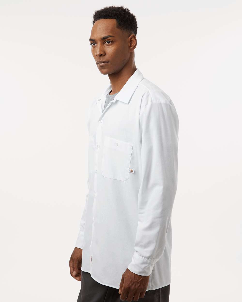 Man wearing a white lab coat on a plain background. Dickie's Men's Industrial long Sleeve Work Shirt, Embroidered by Helmsman Stitch Co.
