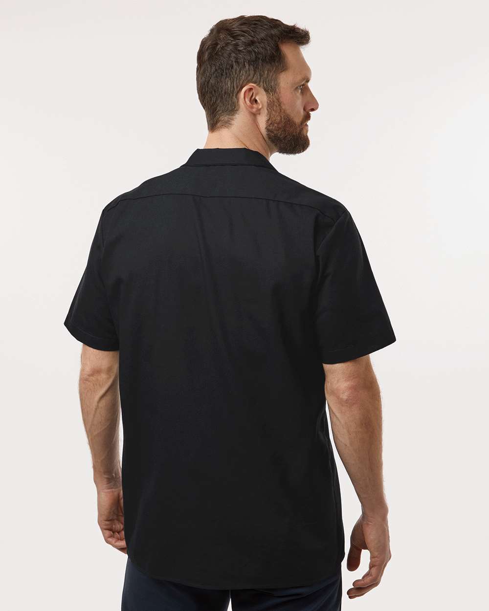 Man wearing a black short-sleeve shirt on a white background. Dickie's Men's Industrial Short Sleeve Work Shirt, Embroidered by Helmsman Stitch Co.