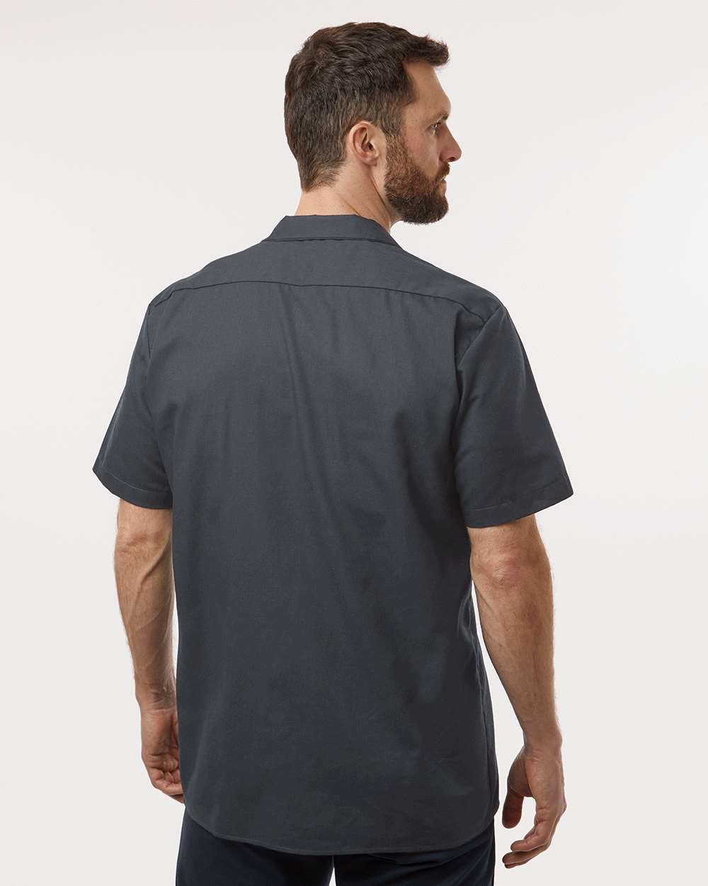 Man wearing a dark gray short-sleeve shirt on a white background. Dickie's Men's Industrial Short Sleeve Work Shirt, Embroidered by Helmsman Stitch Co.