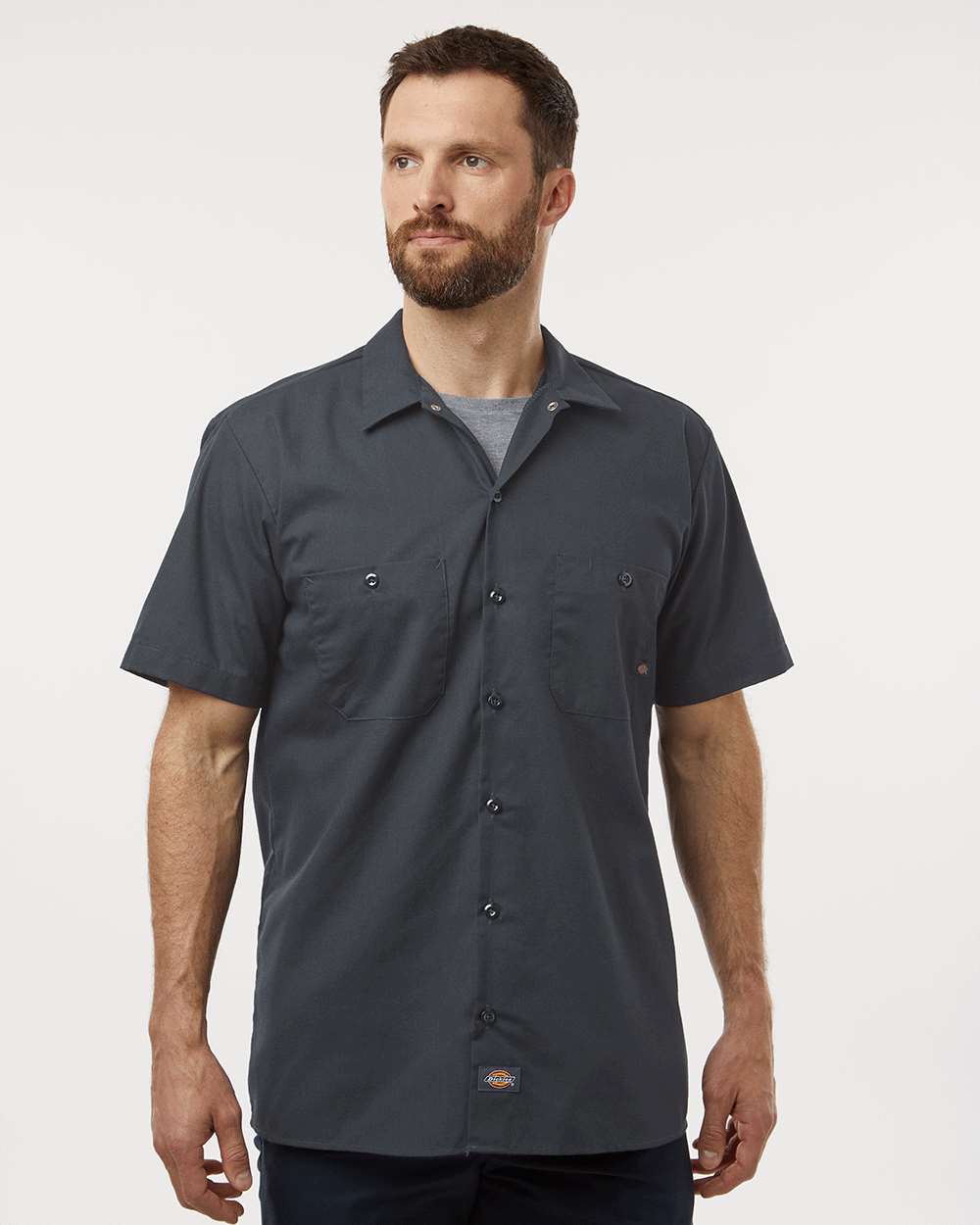 Man wearing a dark gray short-sleeve shirt on a white background. Dickie's Men's Industrial Short Sleeve Work Shirt, Embroidered by Helmsman Stitch Co.