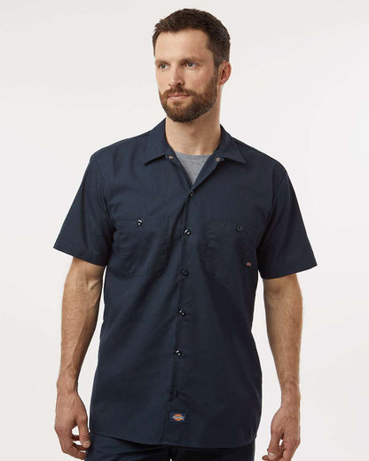 Man wearing a navy short-sleeve shirt on a white background. Dickie's Men's Industrial Short Sleeve Work Shirt, Embroidered by Helmsman Stitch Co.