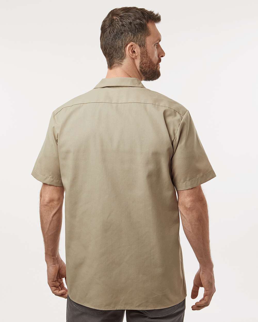 Man wearing a beige short-sleeve shirt on a white background. Dickie's Men's Industrial Short Sleeve Work Shirt, Embroidered by Helmsman Stitch Co.