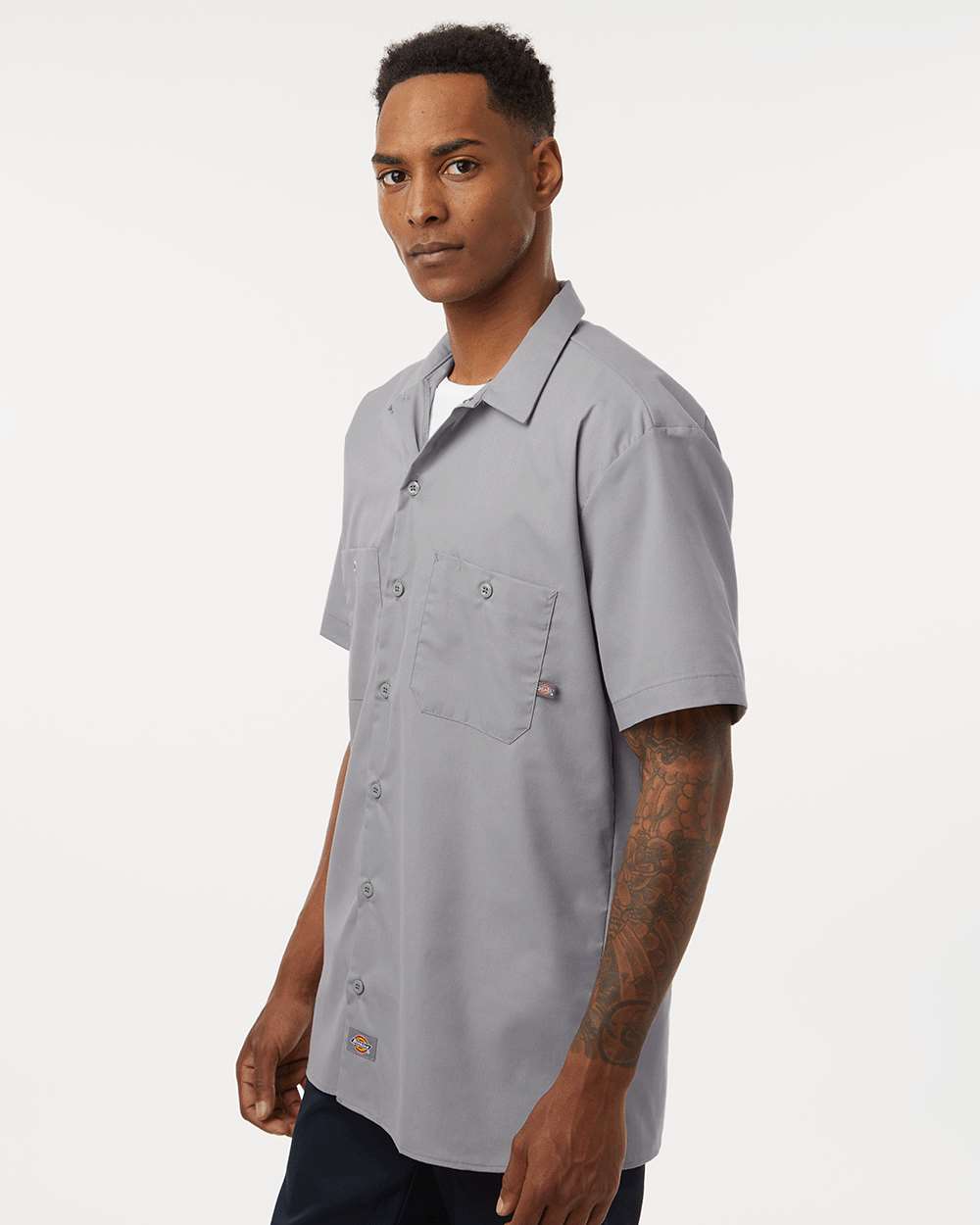 Man wearing a gray short-sleeve work shirt on a white background. Dickie's Men's Industrial Short Sleeve Work Shirt, Embroidered by Helmsman Stitch Co.