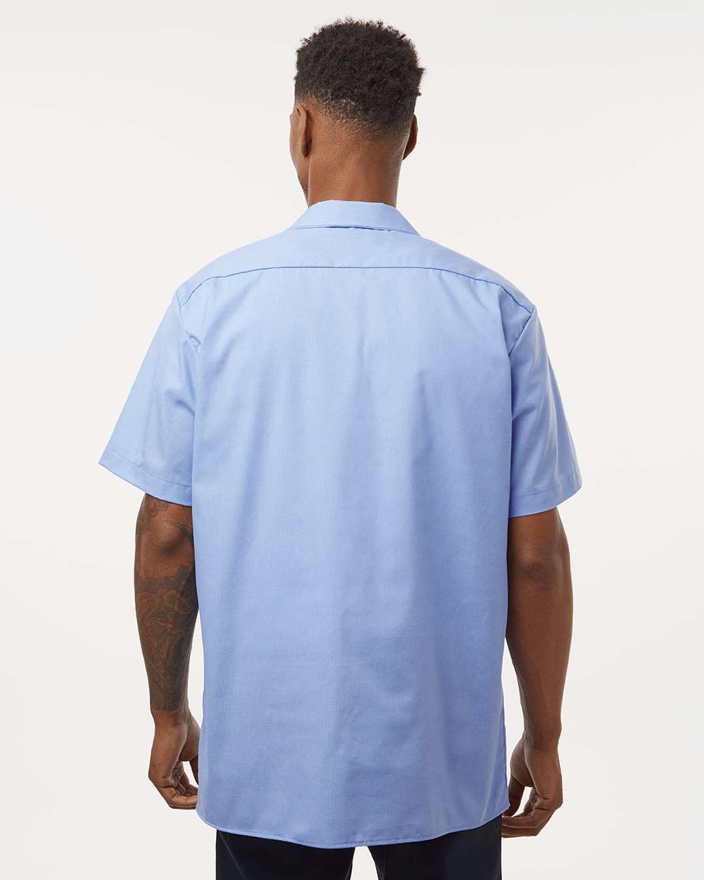 Man wearing a light blue short-sleeve shirt on a white background. Dickie's Men's Industrial Short Sleeve Work Shirt, Embroidered by Helmsman Stitch Co.