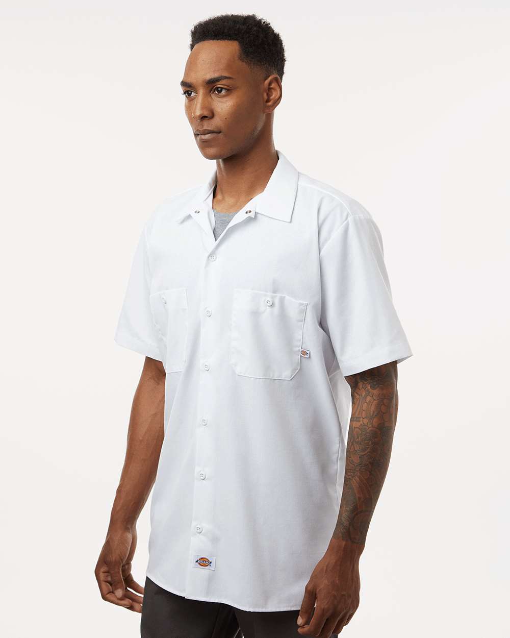 Man wearing a white short-sleeve button-up shirt on a white background. Dickie's Men's Industrial Short Sleeve Work Shirt, Embroidered by Helmsman Stitch Co.
