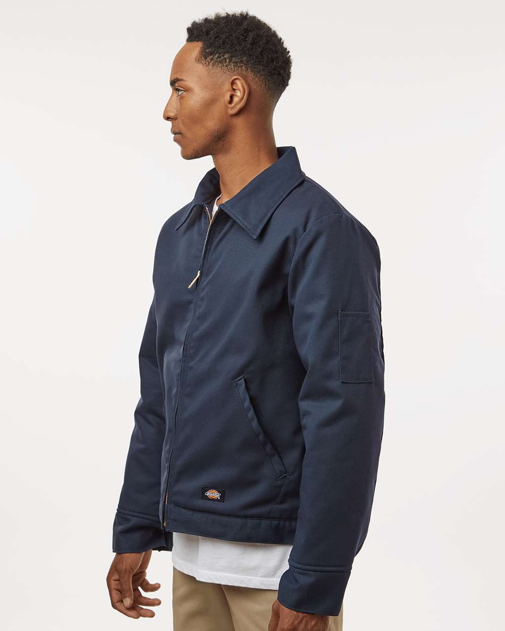 Man wearing a navy blue jacket on a white background. Dickie's Unisex Insulated Industrial Eisenhower Jacket, Embroidered