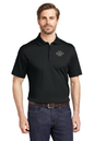Man wearing a black polo shirt with a logo on a white background, Eddie Bauer® Performance Polo, Embroidered