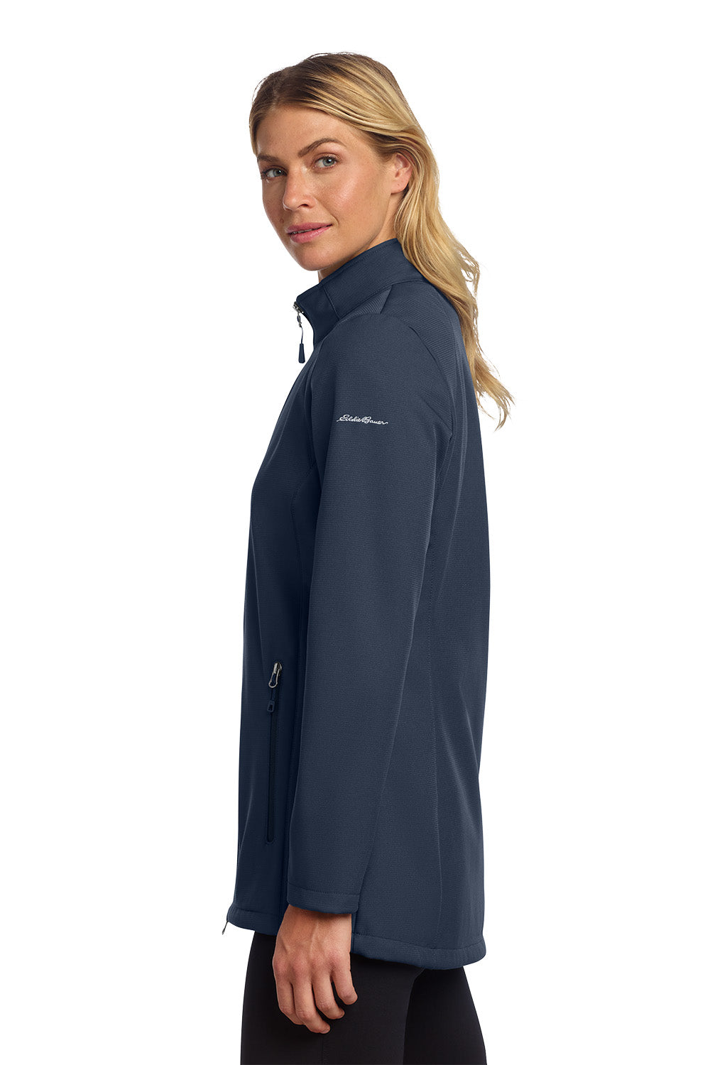 Woman wearing a navy blue jacket with a brand logo on a white background embroidered Eddie Bauer® Women's Stretch Soft Shell Jacket