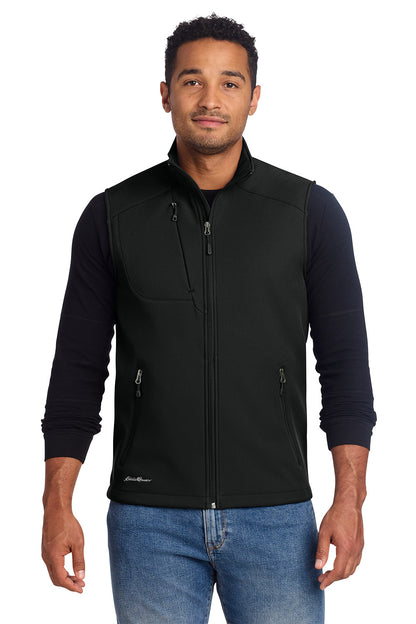 Man wearing a black vest over a dark long-sleeve shirt with a white background, embroidered Eddie Bauer® Stretch Soft Shell Vest