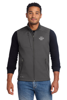 Man wearing a gray vest with a logo on a white background embroidered Eddie Bauer® Stretch Soft Shell Vest