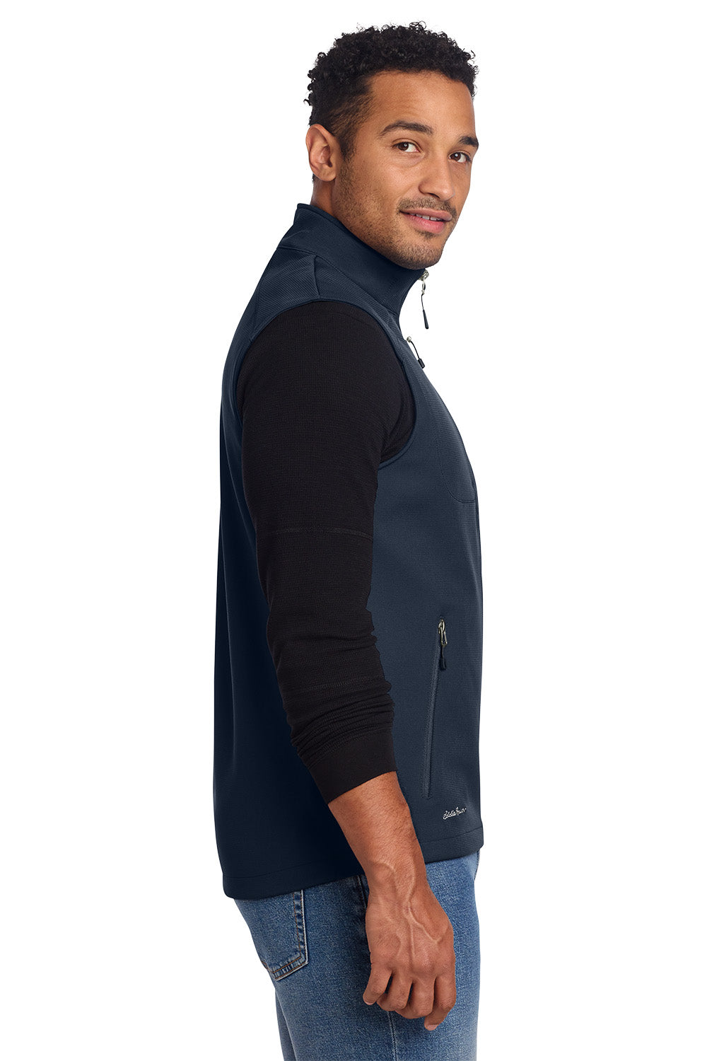 Man wearing a navy blue vest over a black shirt on a white background, embroidered Eddie Bauer® Stretch Soft Shell Vest