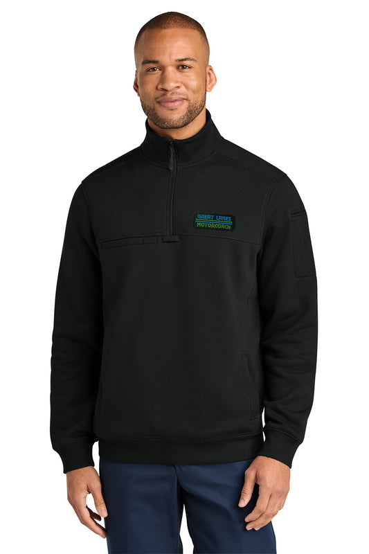 A man wearing a black quarter-zip pullover sweatshirt with a mock neck and a small black logo on the left sleeve, paired with navy blue pants, against a solid white background. CornerStone® 12-Oz. Tough Fleece Job Shirt, great lakes motorcoach