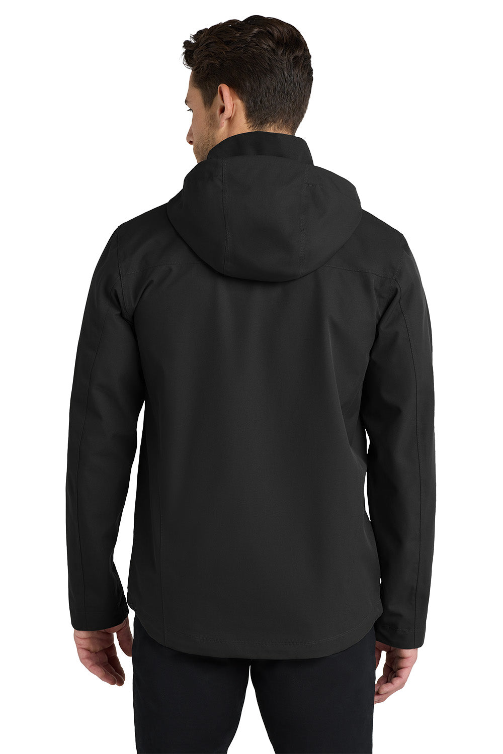 A man viewed from the back wearing a black hooded jacket and black pants against a plain white studio background. Port Authority® Collective Outer Shell Jacket, Embroidered